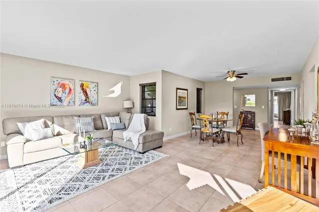 a living room with furniture and a painting on the wall