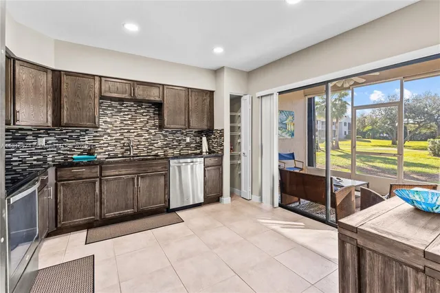 a kitchen with stainless steel appliances kitchen island granite countertop a sink and cabinets