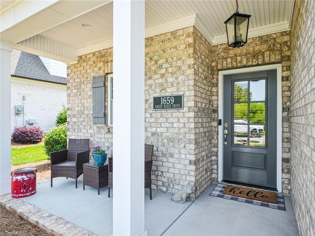 1659 Angus Ridge Drive Kernersville, NC 27284 - Photo 2 of 34 Wave to your neighbors from the covered front porch! Gaze out to green space!