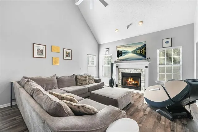 a kitchen with granite countertop stainless steel appliances a stove oven a sink dishwasher and white cabinets with wooden floor