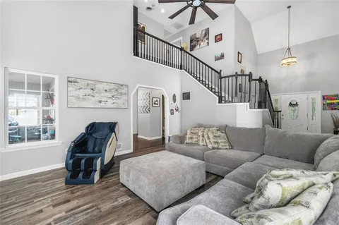 a kitchen with granite countertop white cabinets and white appliances