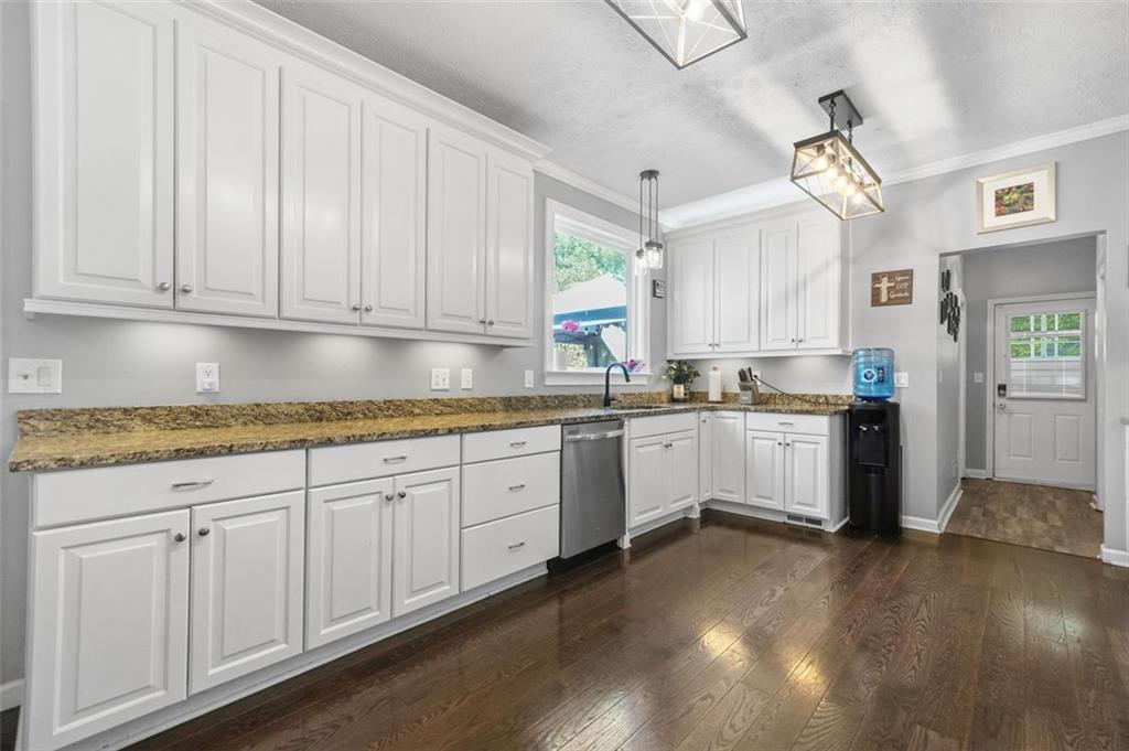4835 Liberty Road Villa Rica, GA 30180 - Photo 17 of 72 a kitchen with granite countertop white cabinets and white appliances