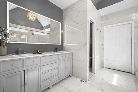 a view of a hallway with wooden floor and entryway