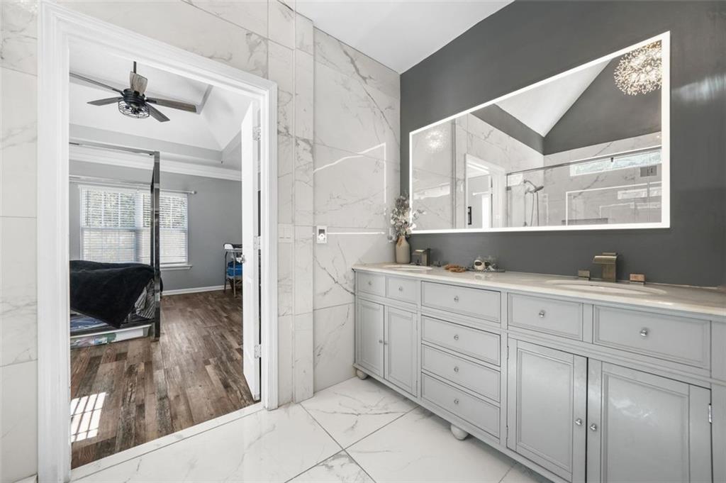 4835 Liberty Road Villa Rica, GA 30180 - Photo 26 of 72 a spacious bathroom with a shower sink and mirror