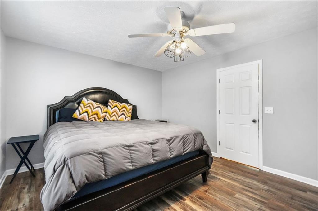 4835 Liberty Road Villa Rica, GA 30180 - Photo 34 of 72 a bedroom with a bed and a chandelier