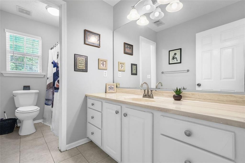 4835 Liberty Road Villa Rica, GA 30180 - Photo 35 of 72 a bathroom with a granite countertop sink mirror and toilet