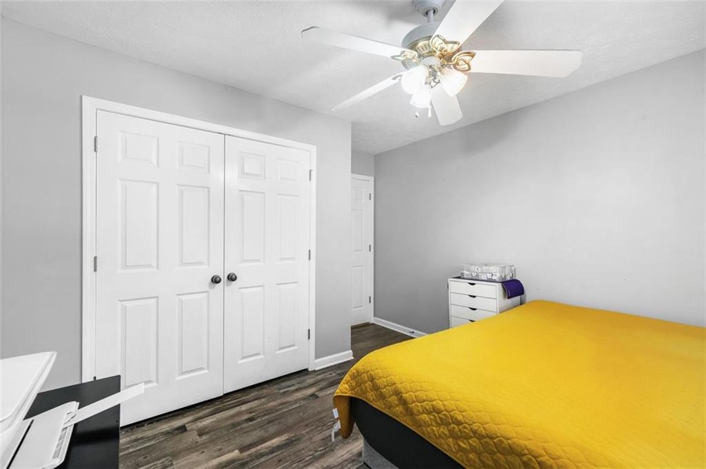 4835 Liberty Road Villa Rica, GA 30180 - Photo 39 of 72 a bedroom with a bed and a chandelier