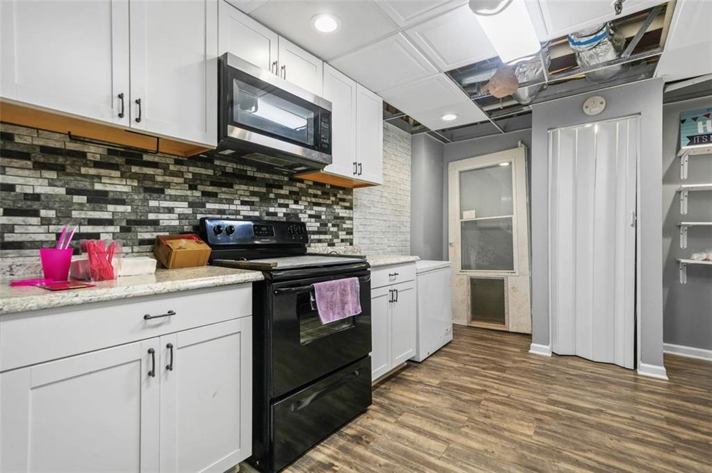4835 Liberty Road Villa Rica, GA 30180 - Photo 45 of 72 a kitchen with stainless steel appliances granite countertop a stove sink and cabinets