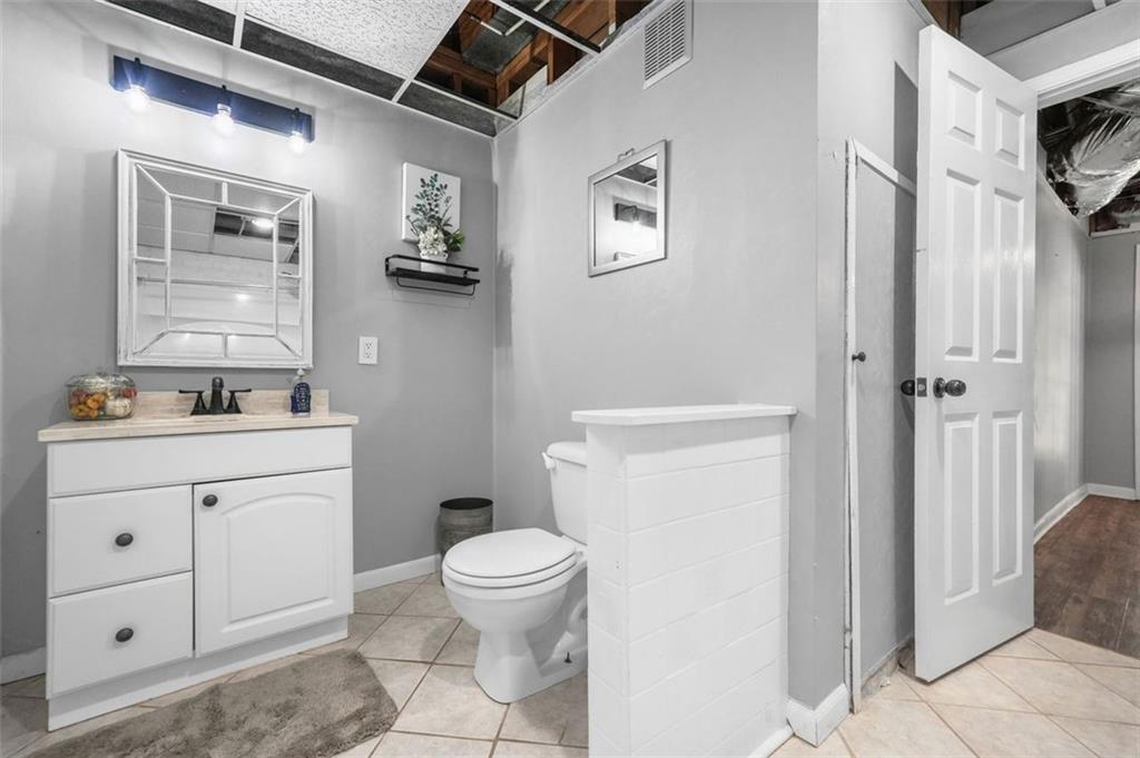 4835 Liberty Road Villa Rica, GA 30180 - Photo 48 of 72 a bathroom with a toilet sink vanity and mirror