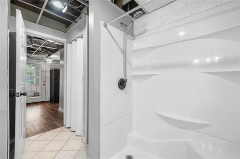 an aerial view of residential houses with outdoor space and trees