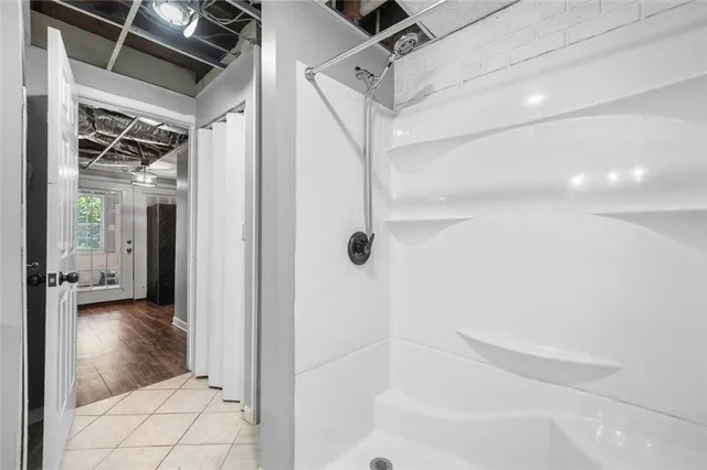 an aerial view of residential houses with outdoor space and trees