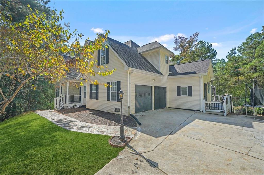 4835 Liberty Road Villa Rica, GA 30180 - Photo 10 of 72 a view of a house with a yard and potted plants
