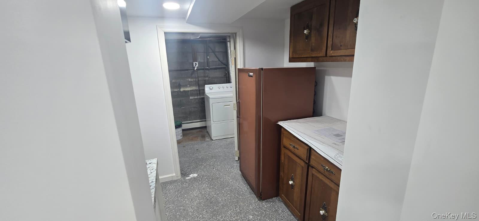 51 Peconic Street Selden, NY 11784 - Photo 12 of 16 a kitchen with a refrigerator and cabinets