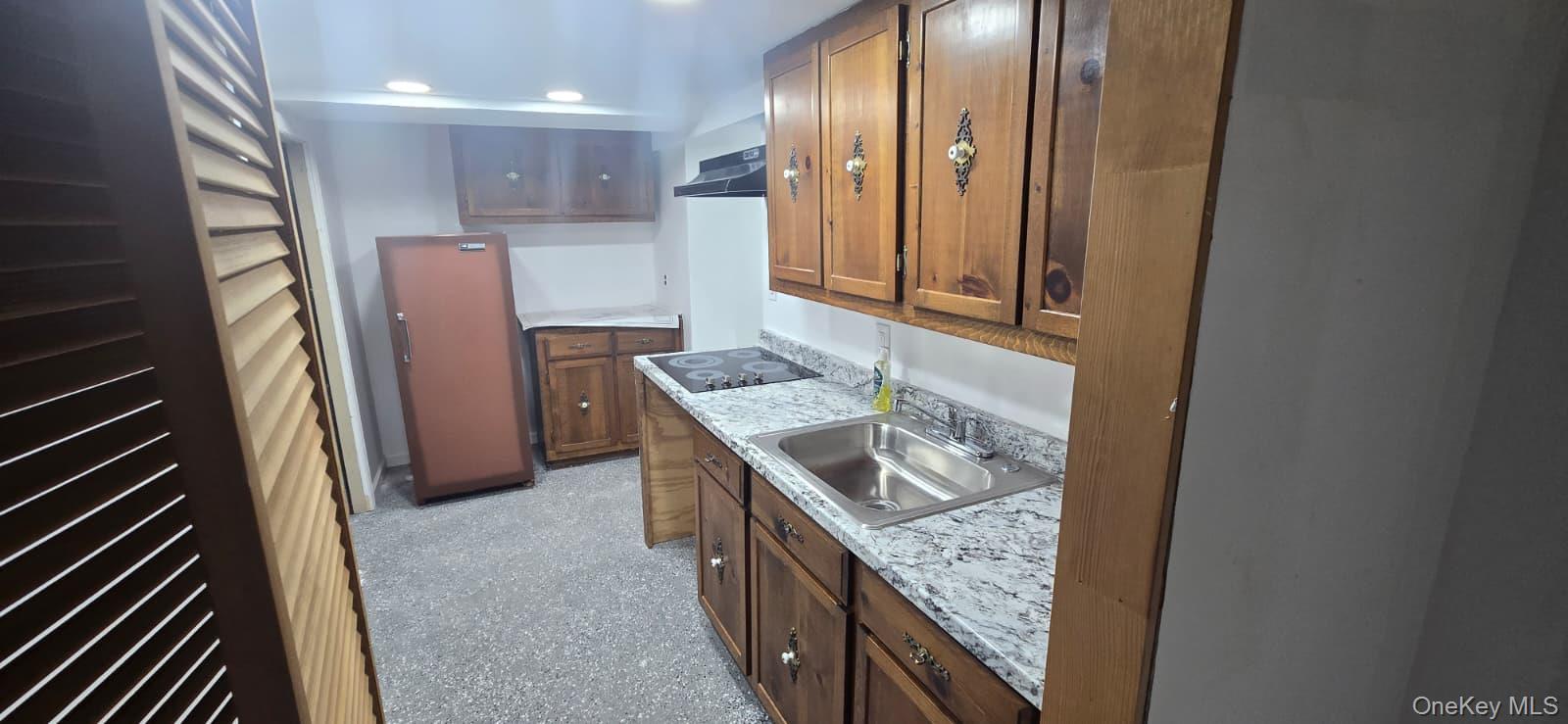 51 Peconic Street Selden, NY 11784 - Photo 15 of 16 a kitchen with granite countertop a sink stove and refrigerator