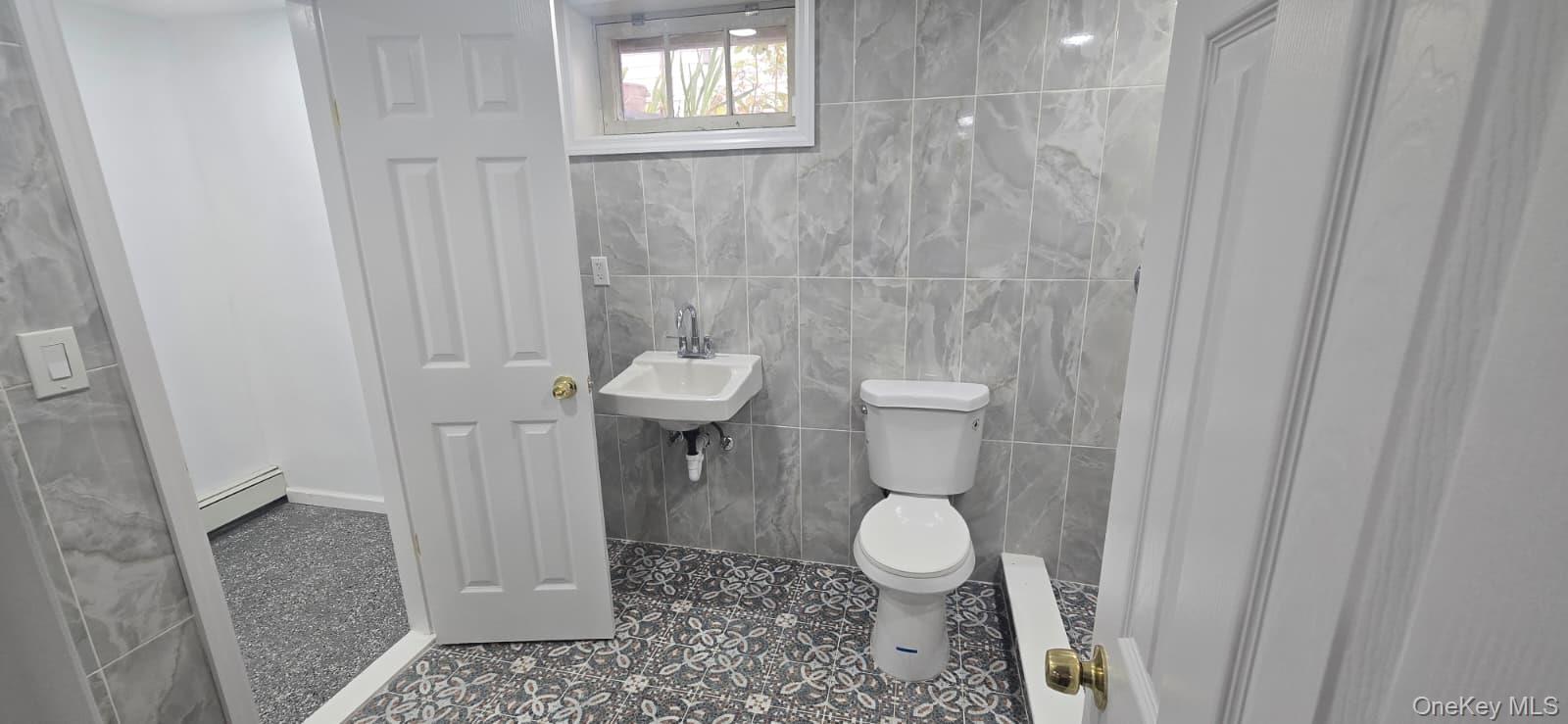 51 Peconic Street Selden, NY 11784 - Photo 2 of 16 a bathroom with a toilet and a shower