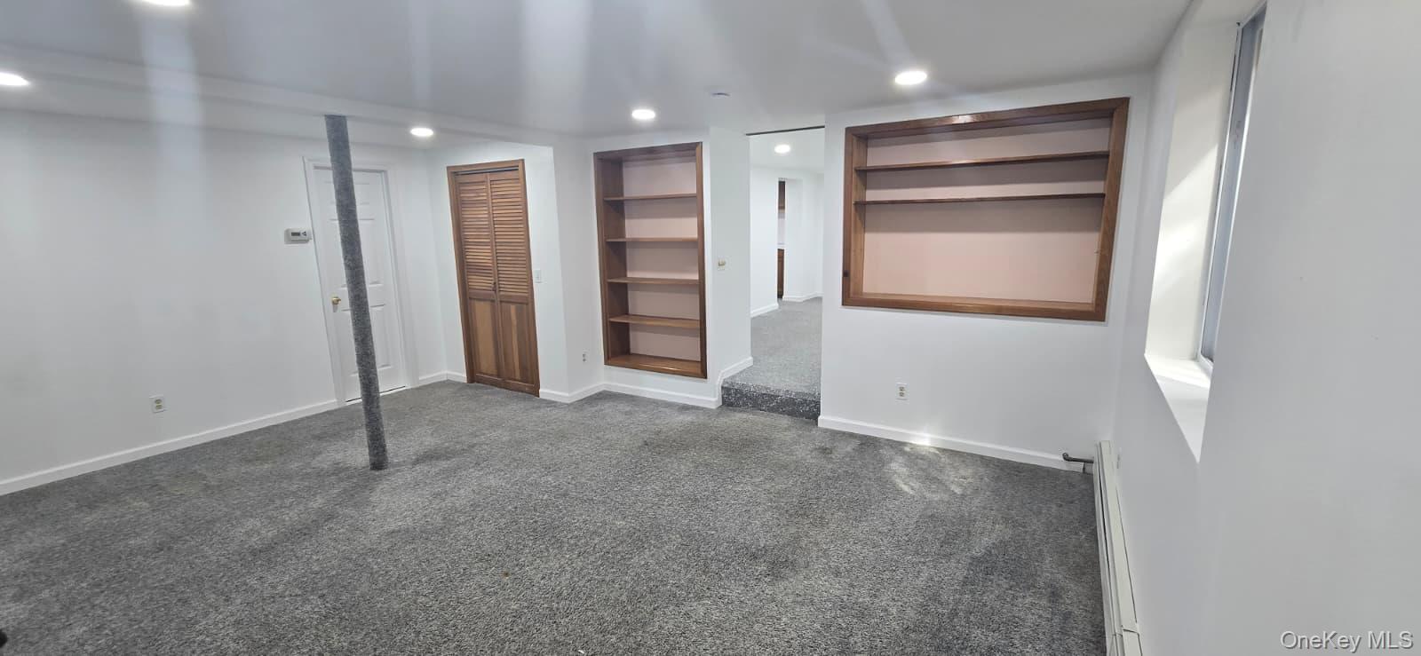 51 Peconic Street Selden, NY 11784 - Photo 5 of 16 an empty room with closet and windows