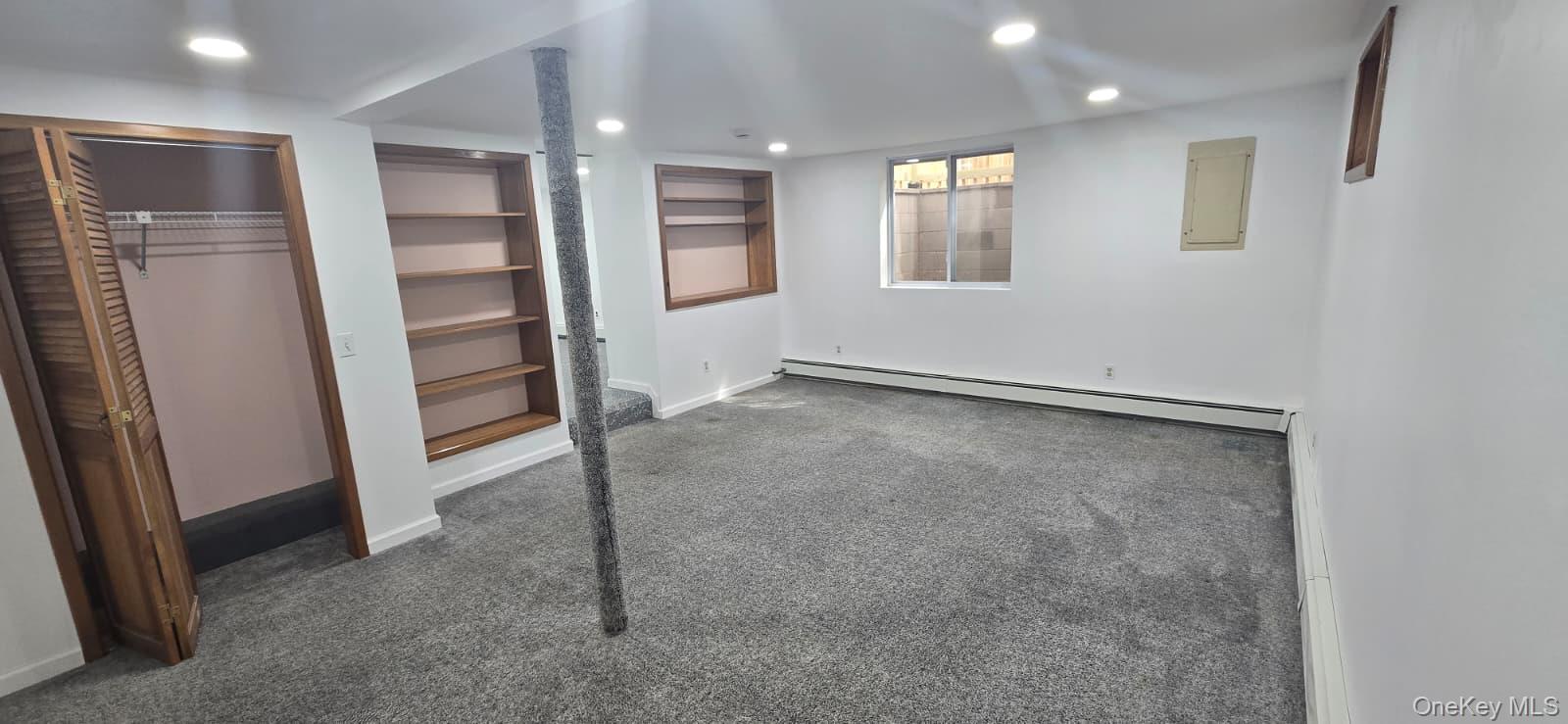 51 Peconic Street Selden, NY 11784 - Photo 7 of 16 an empty room with windows
