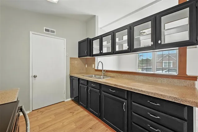 a hallway with sink and mirror