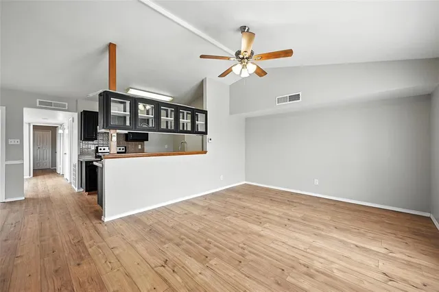 a view of a kitchen with a stove cabinets and wooden floor