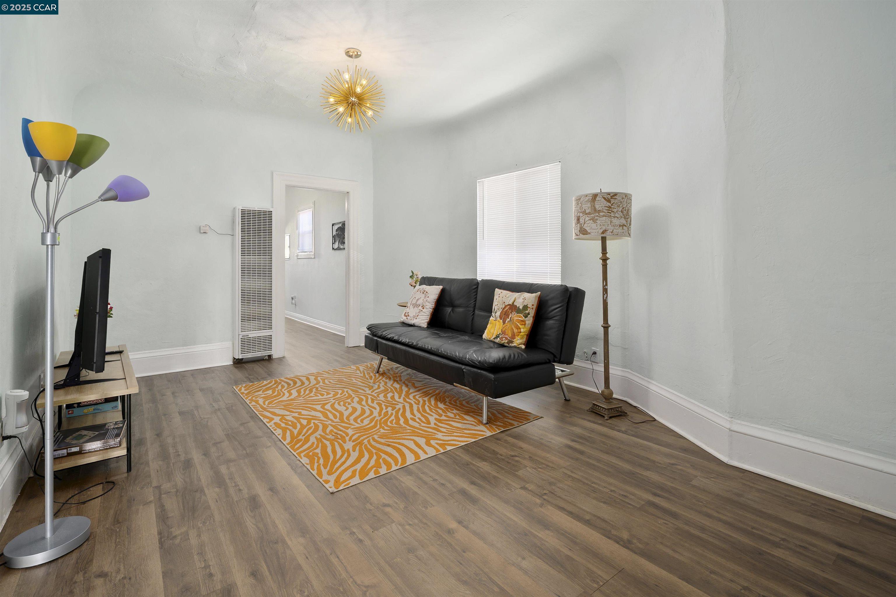 874 36th Street Oakland, CA 94608 - Photo 11 of 41 a living room with furniture and a flat screen tv