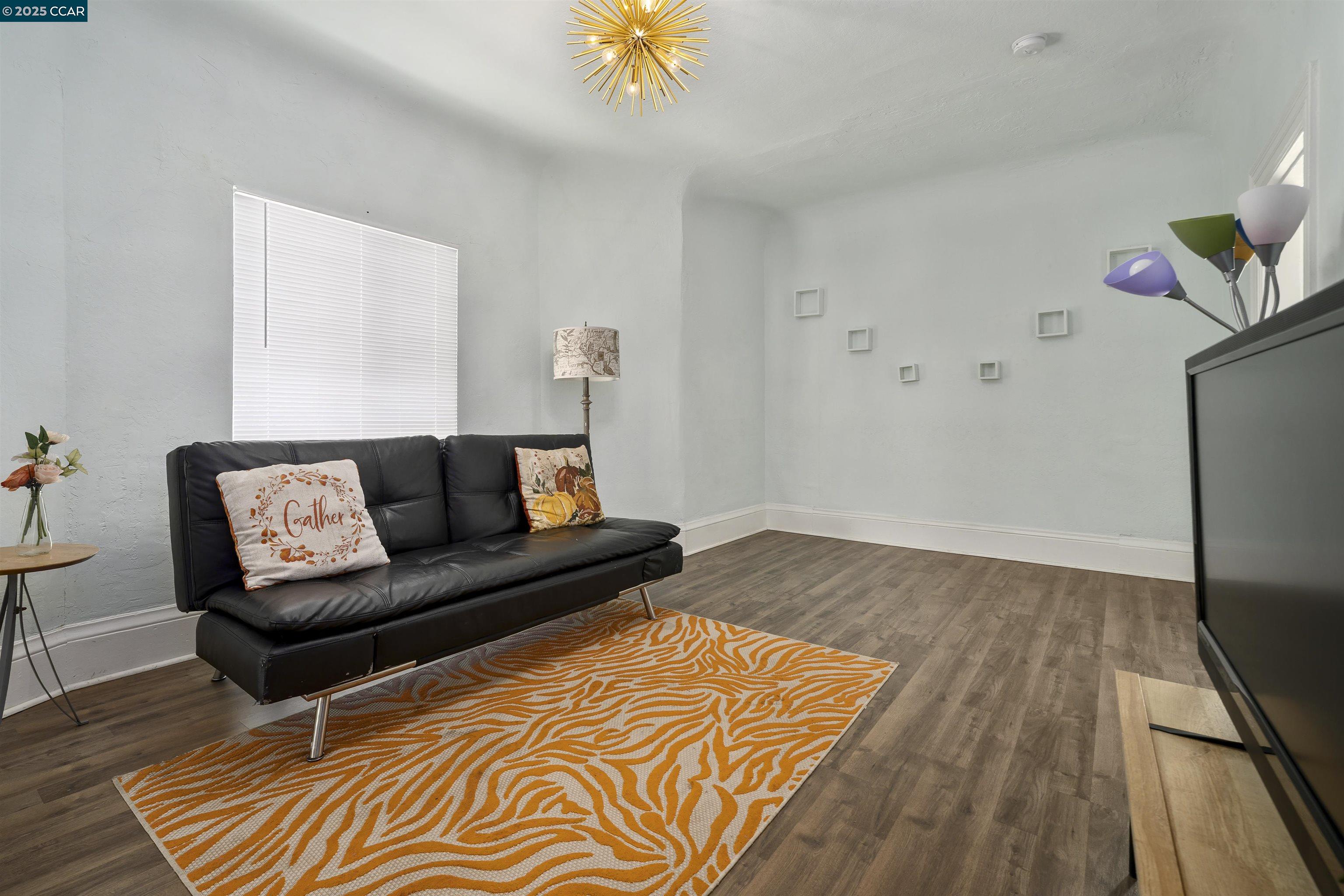 874 36th Street Oakland, CA 94608 - Photo 12 of 41 a living room with a couch and a rug