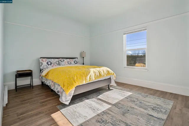 a bed sitting in a bedroom next to a window