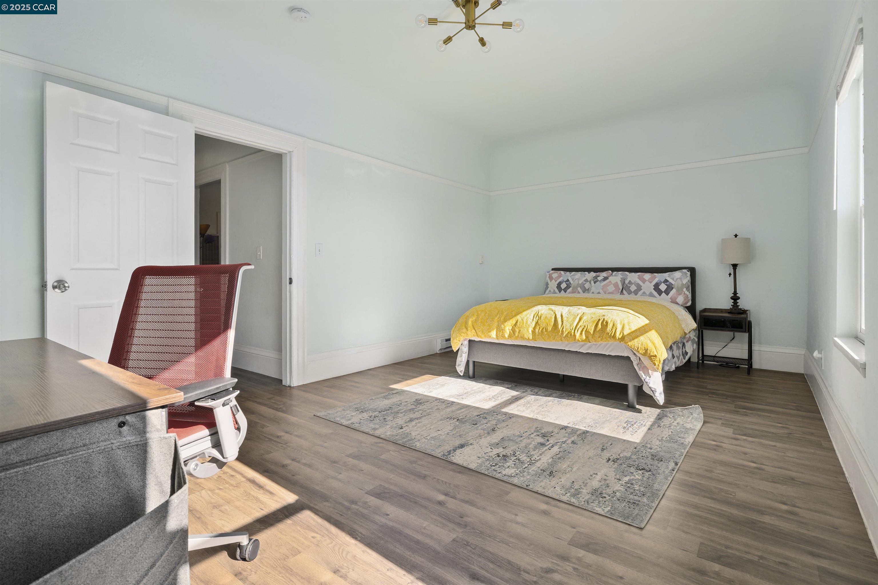 874 36th Street Oakland, CA 94608 - Photo 19 of 41 a room with a bed and a chair