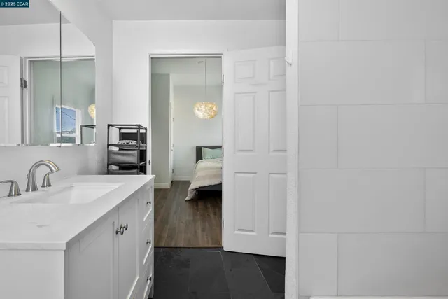 a en suite bathroom with a sink and a mirror