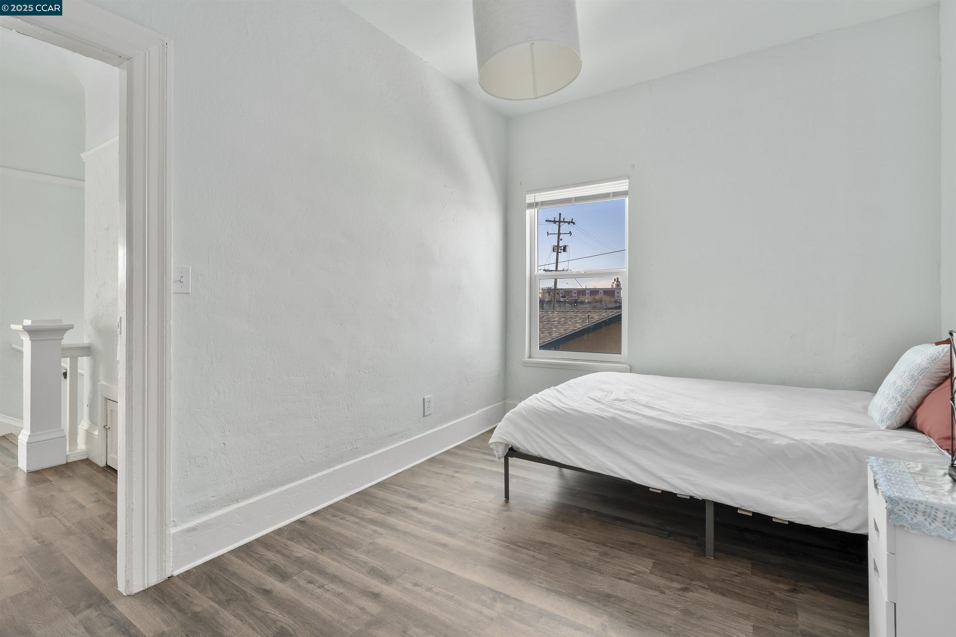 874 36th Street Oakland, CA 94608 - Photo 28 of 41 a bedroom with a bed and a table