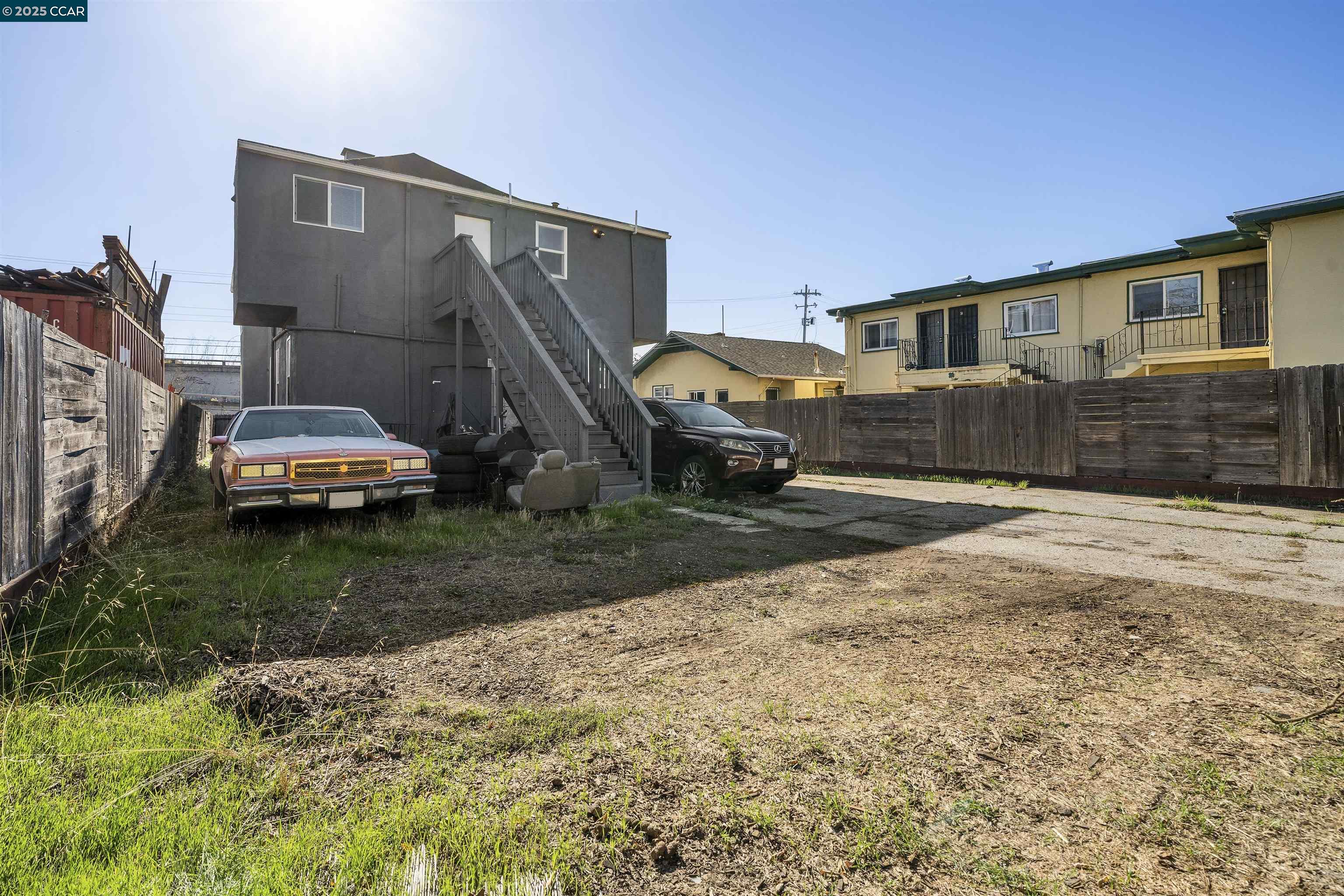 874 36th Street Oakland, CA 94608 - Photo 34 of 41 a front view of a house with a yard and garage
