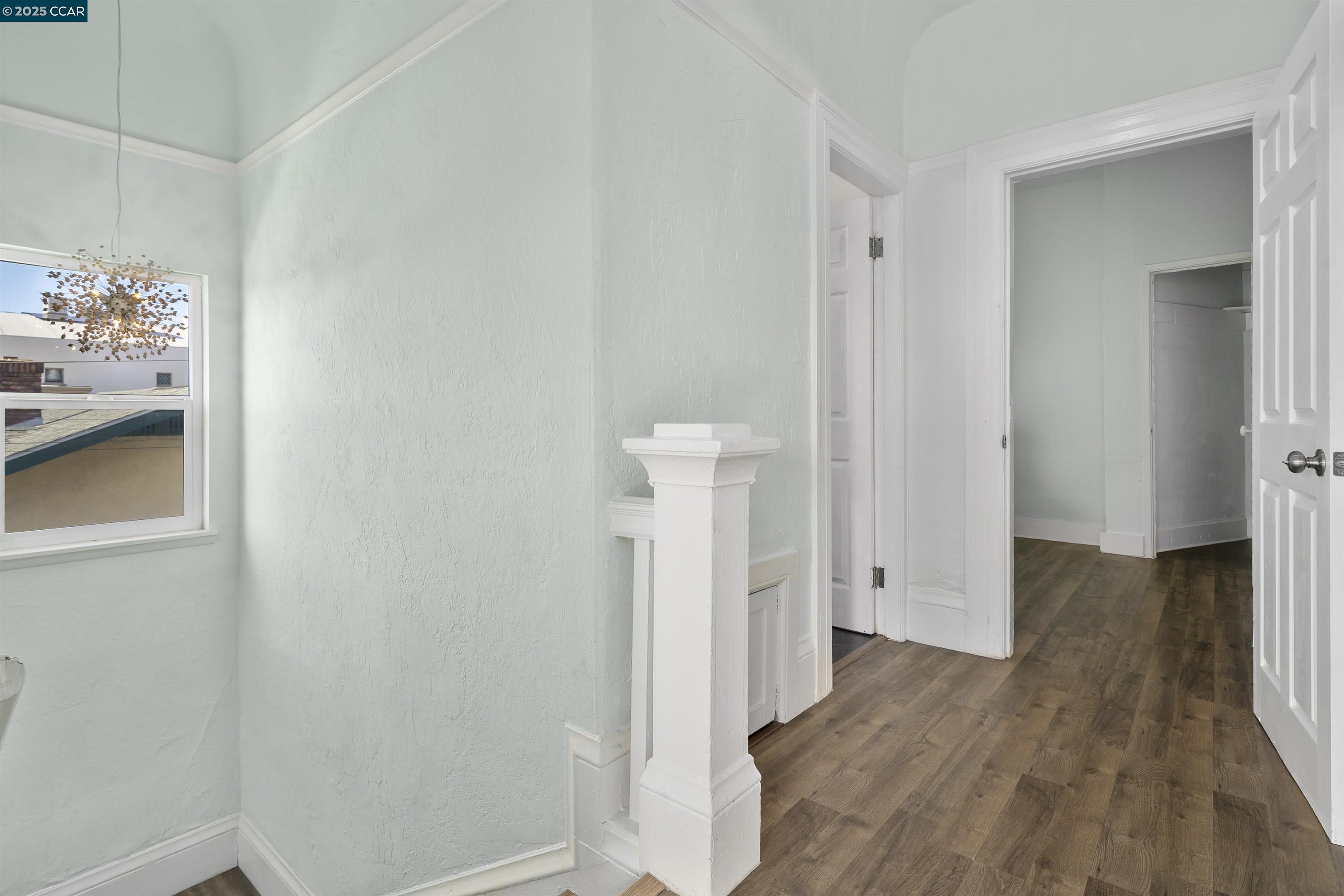 874 36th Street Oakland, CA 94608 - Photo 8 of 41 a view of a hallway with wooden floor