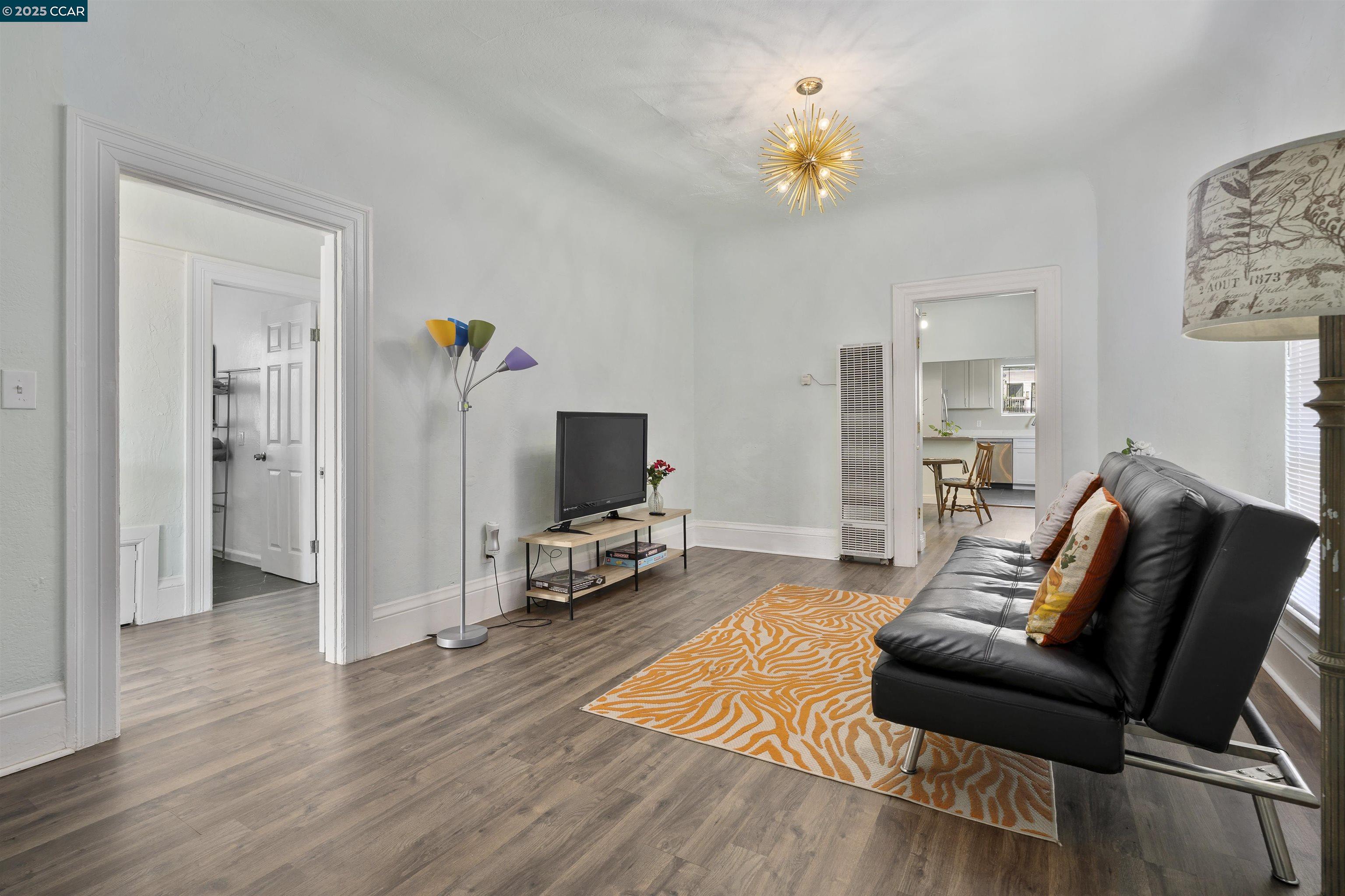 874 36th Street Oakland, CA 94608 - Photo 10 of 41 a living room with furniture and a flat screen tv