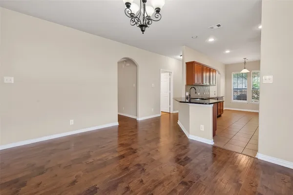 a view of kitchen with stainless steel appliances a refrigerator and wooden floor