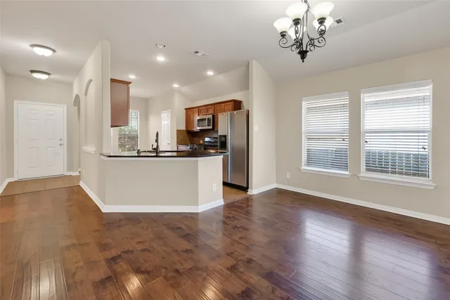 a view of a kitchen with a sink a refrigerator and window