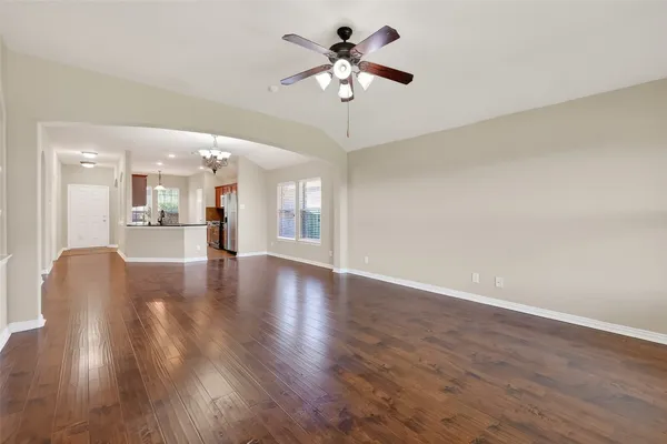 a view of an empty room with a kitchen