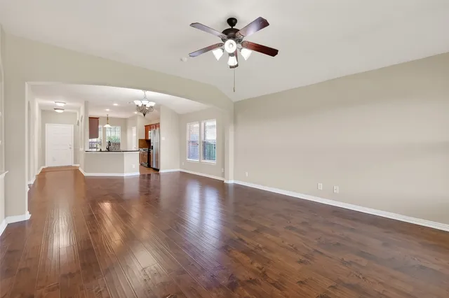 a view of an empty room with a kitchen
