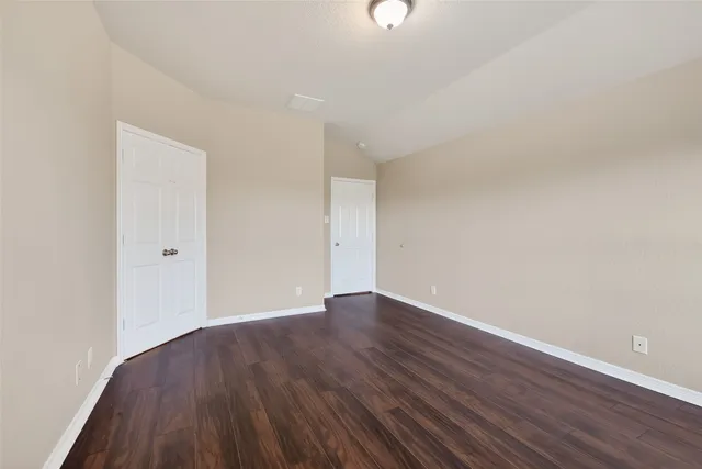 an empty room with wooden floor