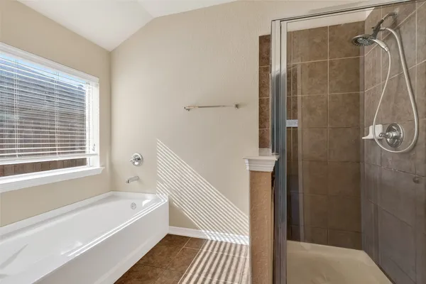 a bathroom with a bathtub and a shower