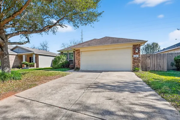 a front view of house with yard and trees around