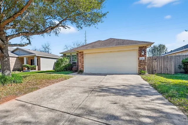a front view of house with yard and trees around
