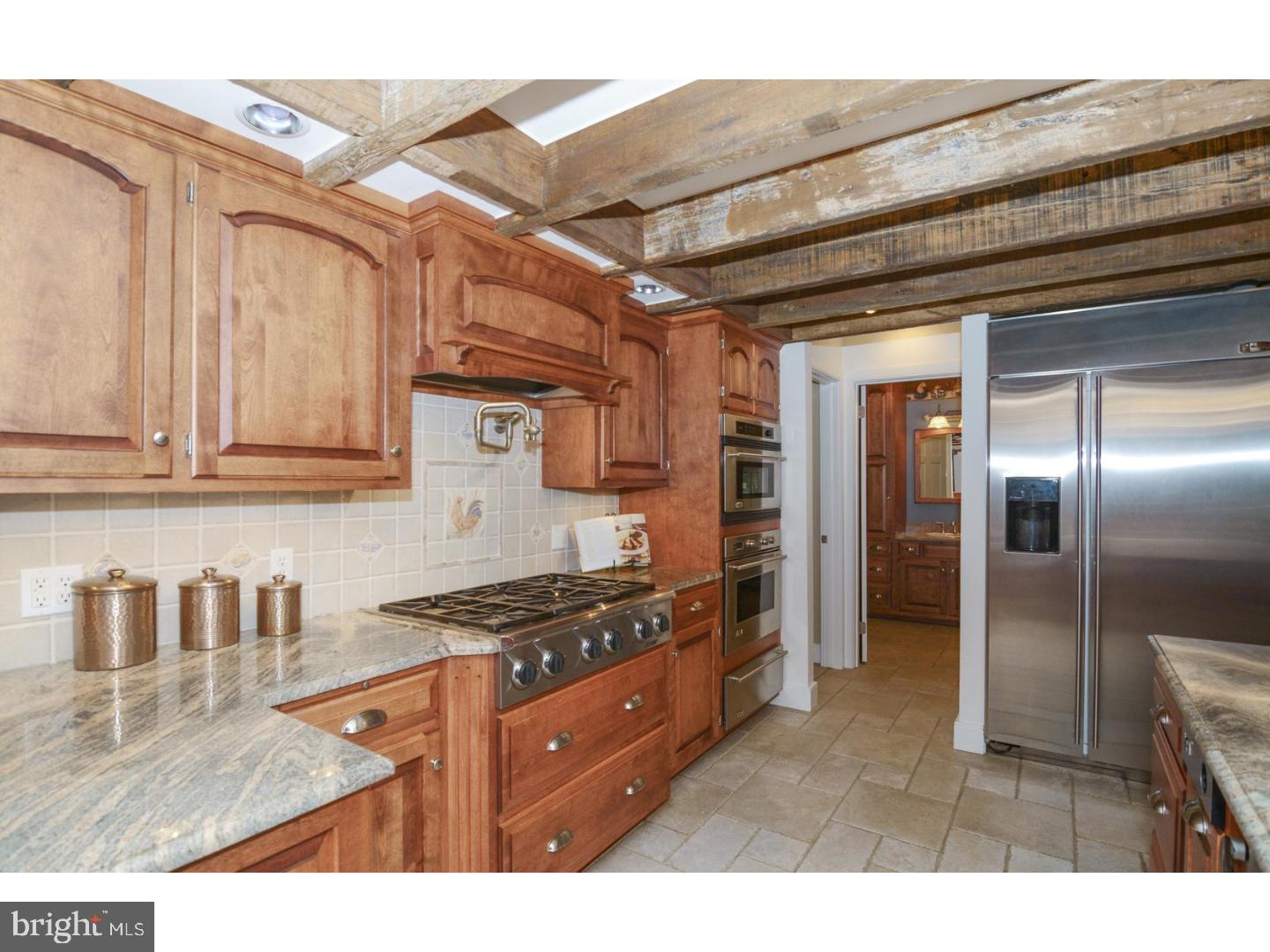 1226 Hollow Road Chester Springs, PA 19425 - Photo 5 of 25 a kitchen with stainless steel appliances granite countertop a refrigerator and a stove