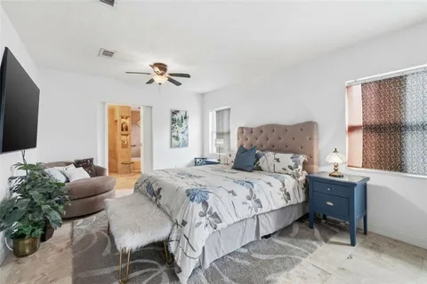 a bedroom with a bed couch and a window