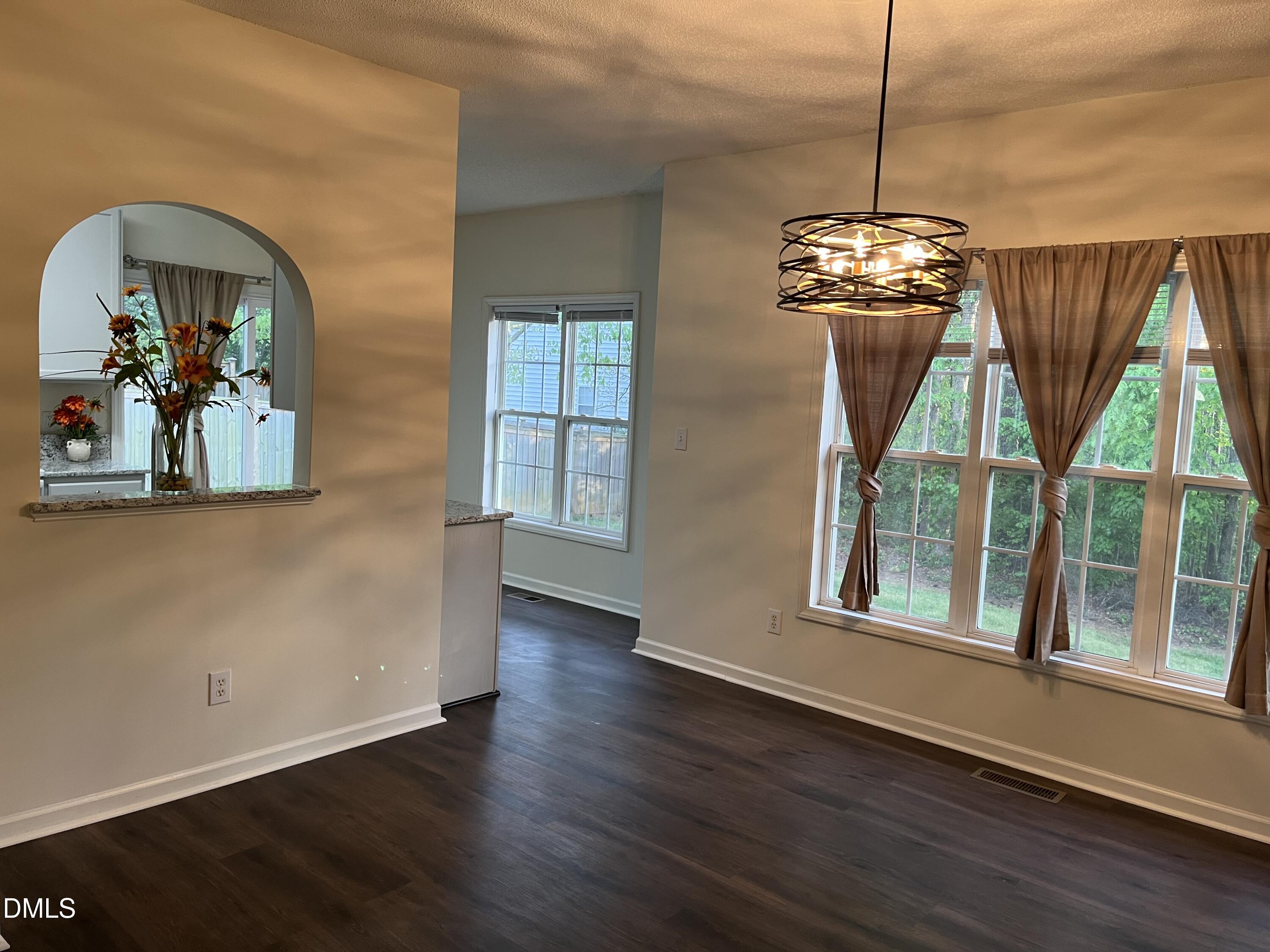 2604 Farlow Gap Lane Raleigh, NC 27603 - Photo 10 of 28 a view of a room with wooden floor chandelier and windows