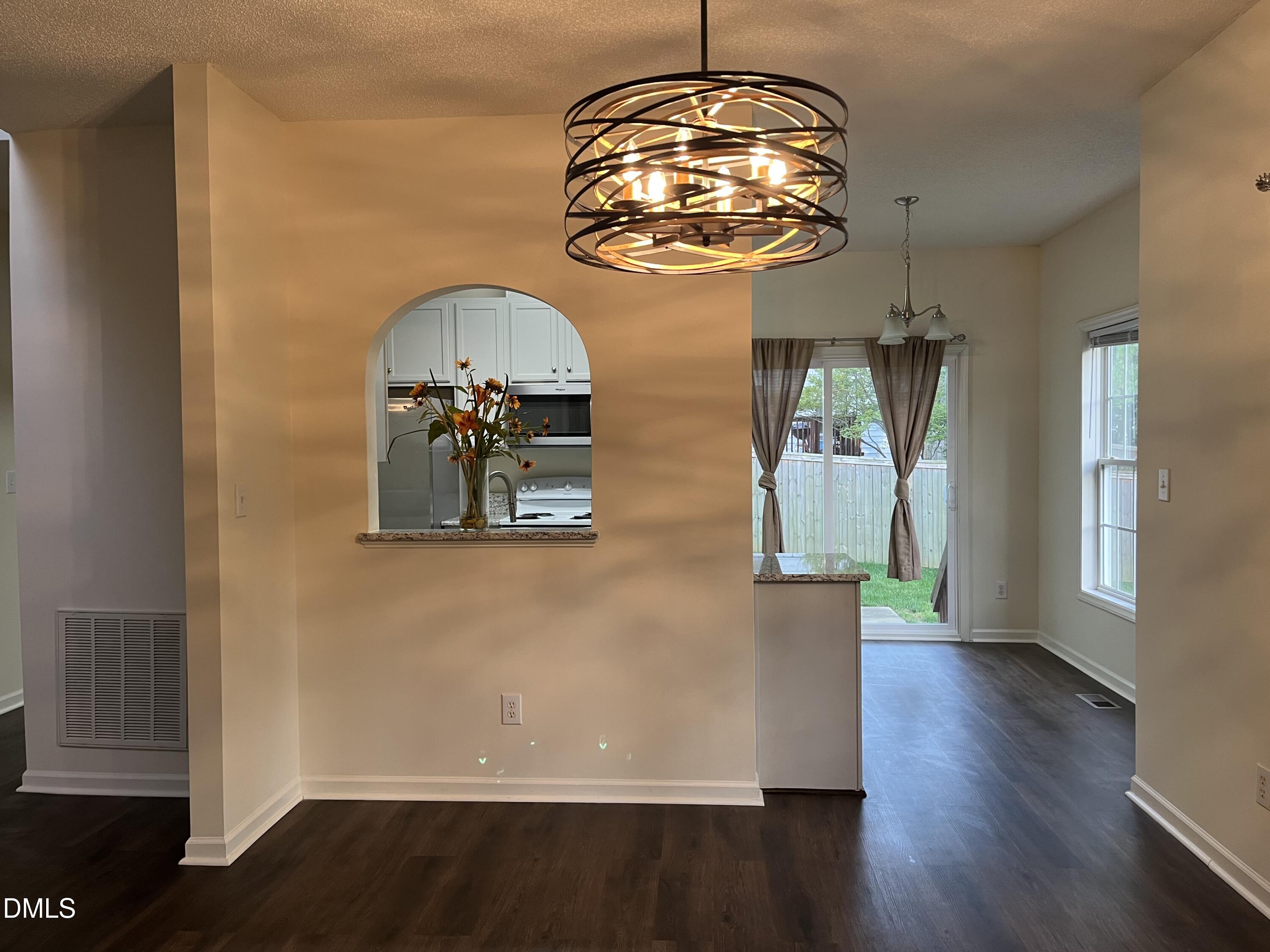 2604 Farlow Gap Lane Raleigh, NC 27603 - Photo 11 of 28 a view of a chandelier in a hall with wooden floor