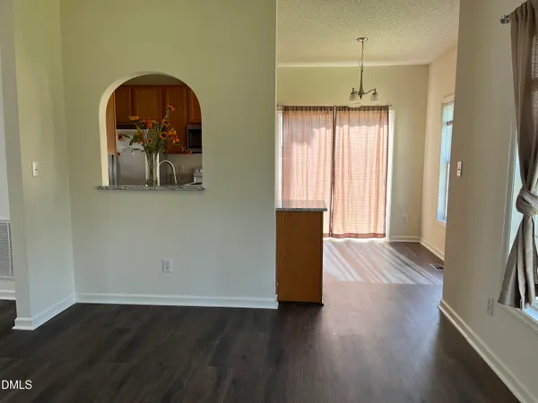 a view of a livingroom with wooden floor and furniture
