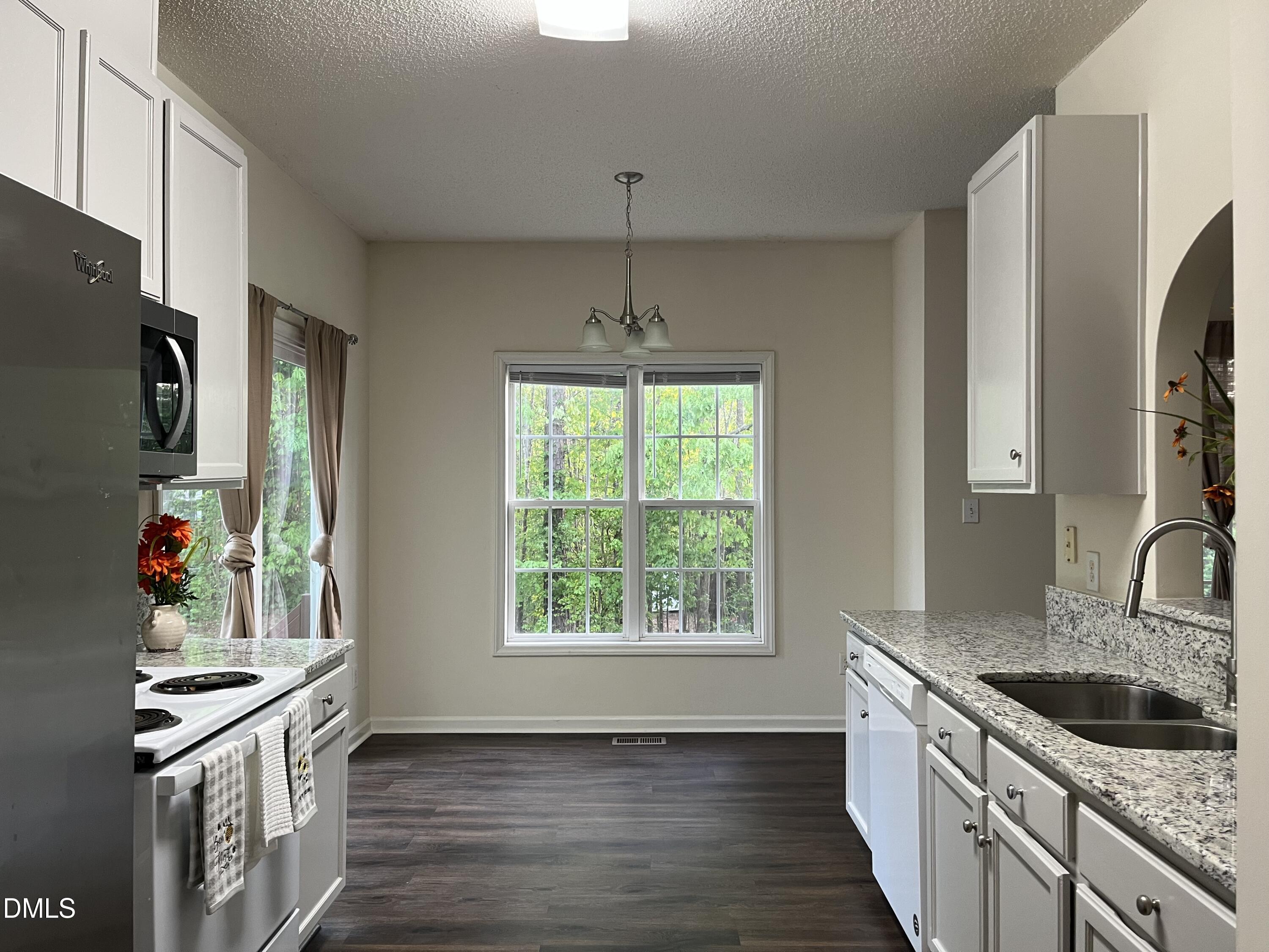 2604 Farlow Gap Lane Raleigh, NC 27603 - Photo 13 of 28 a kitchen with stainless steel appliances granite countertop a sink stove and refrigerator
