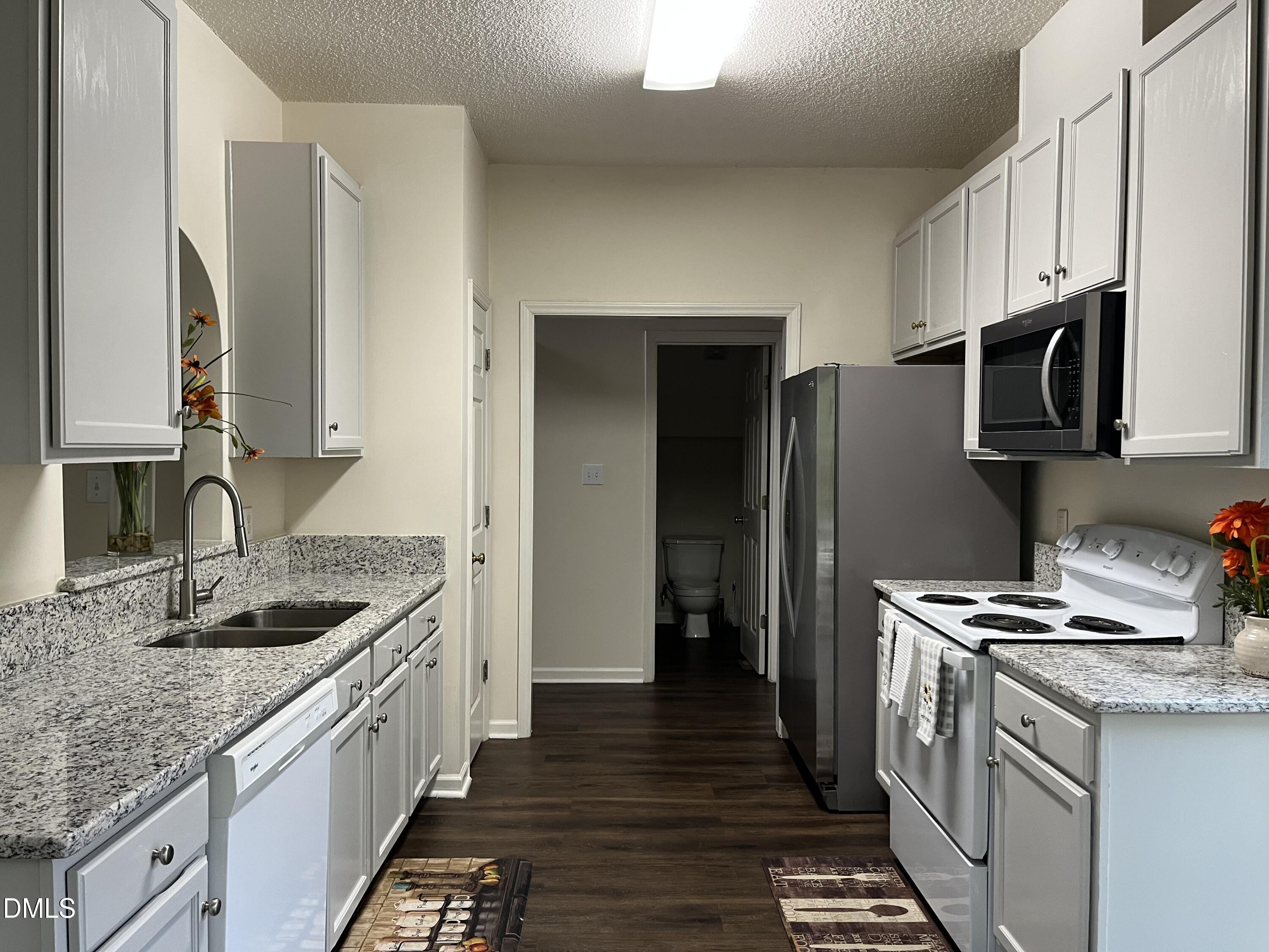 2604 Farlow Gap Lane Raleigh, NC 27603 - Photo 14 of 28 a kitchen with stainless steel appliances granite countertop a sink stove and refrigerator