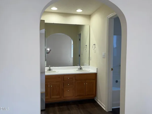 a bathroom with a double vanity sink and mirror