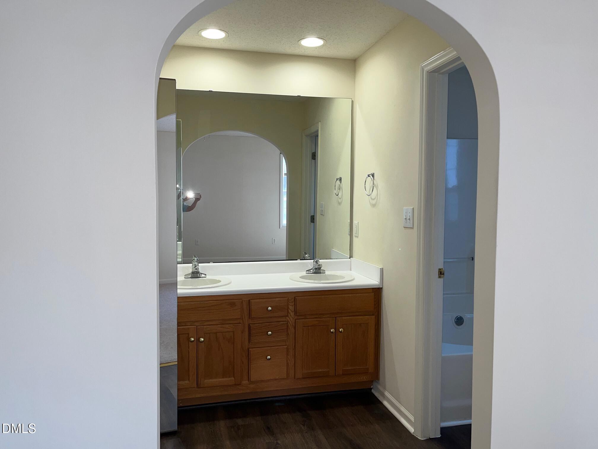 2604 Farlow Gap Lane Raleigh, NC 27603 - Photo 19 of 28 a bathroom with a double vanity sink and mirror