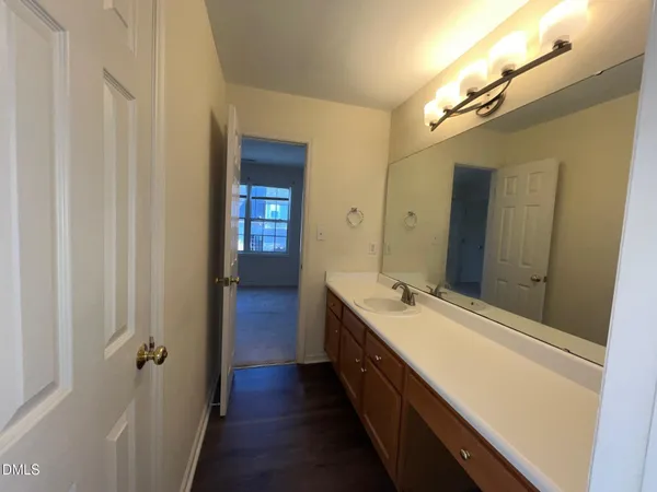 a spacious bathroom with a double vanity sink and a mirror